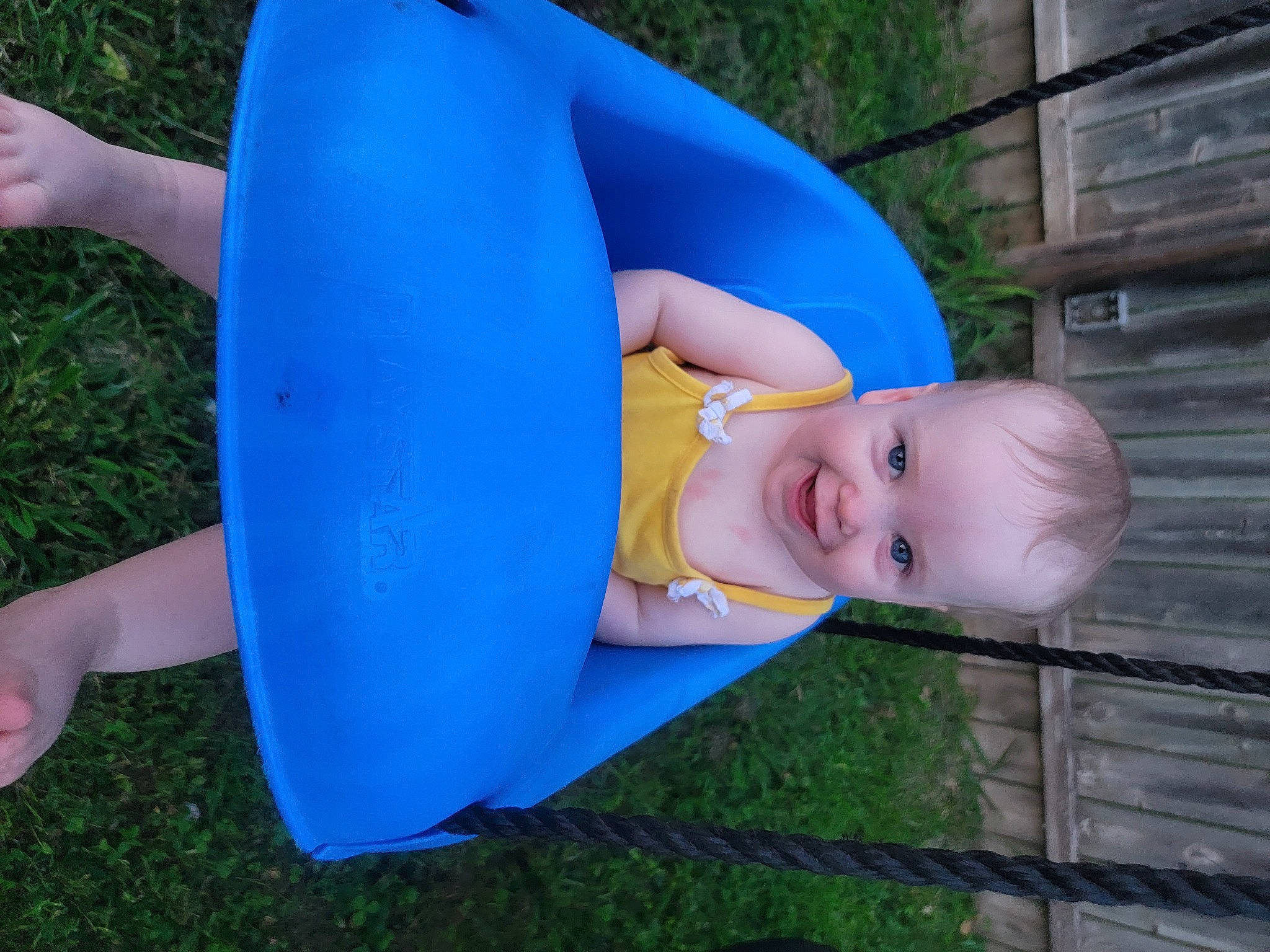 Elliza is registered to the contest to win money with this photo: azure, baby, baby_products, baby_toddler_clothing, child, electric_blue, fun, grass, happy, human_leg, joy, leisure, people_in_nature, person, plastic, recreation, sitting, smile, thigh, toddler