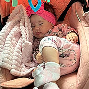 Sofia is registered to the contest to win money with this photo: baby, sleeping, pink, car_seat, blanket, headband, pajamas, toy, soft_texture, child, infant, cute, cozy, indoor, rest, peaceful, face, hand, foot, sock