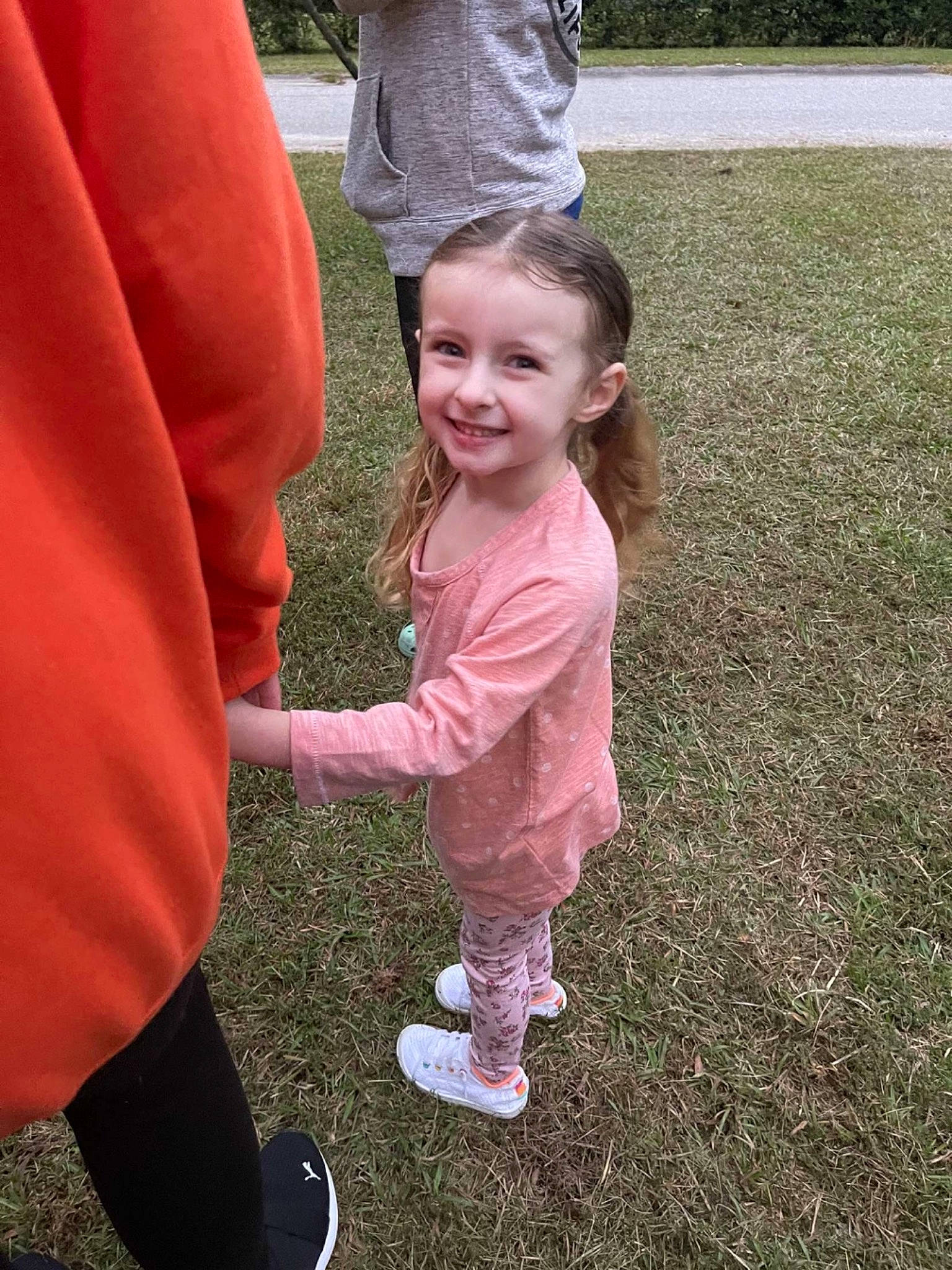 Harper is registered to the contest to win money with this photo: cap, eye, face, fun, gesture, grass, happy, hat, head, joy, leisure, people_in_nature, person, pink, plant, recreation, shoe, smile, sneakers, standing