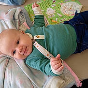 Daymian joined the competition — help win amazing prizes! baby, infant, smile, table, clothing, sweater, jeans, pacifier, activity_sheet, jacket, indoor, child, cute, person, face, hand, toy, play, colorful, relaxed