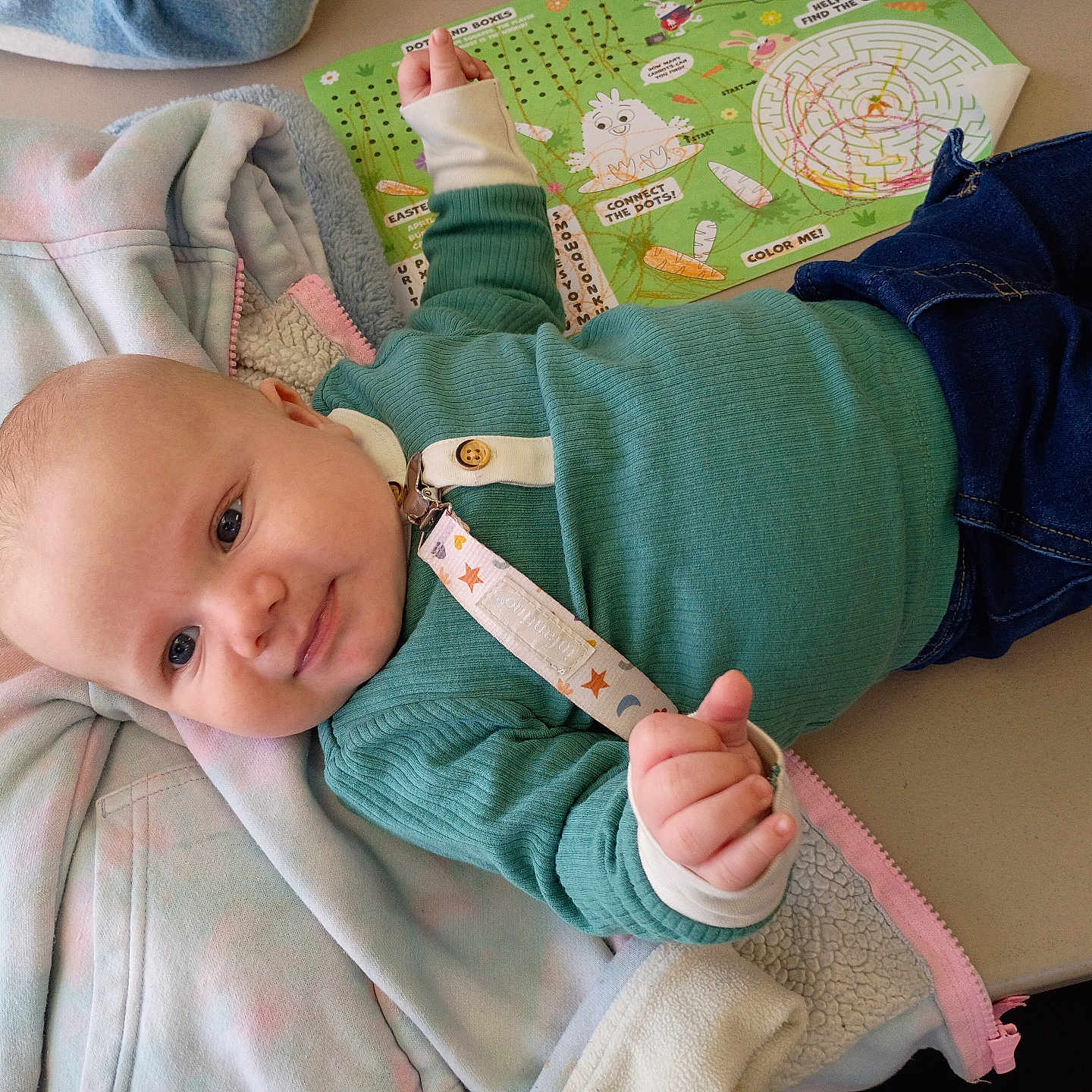 Daymian joined the competition — help win amazing prizes! baby, infant, smile, table, clothing, sweater, jeans, pacifier, activity_sheet, jacket, indoor, child, cute, person, face, hand, toy, play, colorful, relaxed