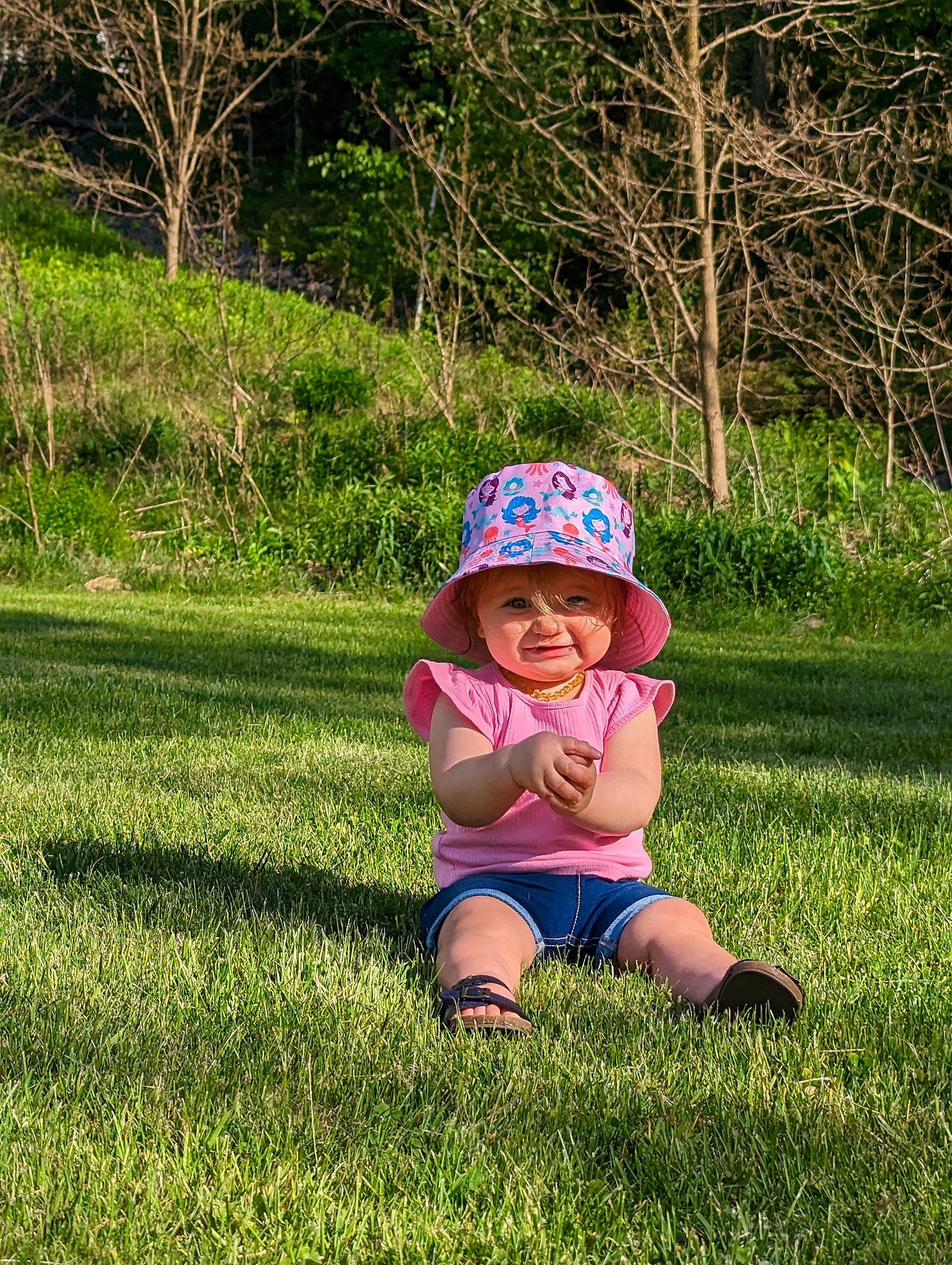 Aviana joined the competition — help win amazing prizes! baby, baby_toddler_clothing, cap, electric_blue, grass, grassland, happy, hat, headwear, landscape, lawn, leisure, meadow, people_in_nature, person, plant, recreation, sitting, smile, sun_hat