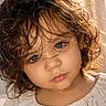 blue_eyes, child, close_up, curly_hair, cute, expression, eyelashes, face, head, innocent, mouth, natural_light, nostrils, portrait, skin, soft_light, toddler, white_clothing, young_child