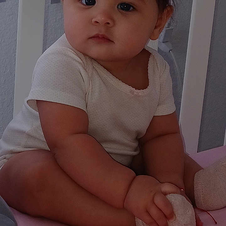 Ahitana. is registered to the contest to win money with this photo: baby, bed, bodypart, clothing, couch, crib, diaper, face, finger, furniture, hand, head, homedecor, indoors, infantbed, person, photography, portrait, sitting, t_shirt