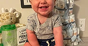 Jax joined the competition — help win amazing prizes! baby, boy, smile, happy, sitting, floor, plush_toy, giraffe, diaper_cake, balloon, its_a_boy, onesie, shorts, baby_clothes, face, hands, feet, indoor, table, framed_poster