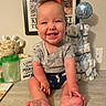 baby, boy, smile, happy, sitting, floor, plush_toy, giraffe, diaper_cake, balloon, its_a_boy, onesie, shorts, baby_clothes, face, hands, feet, indoor, table, framed_poster