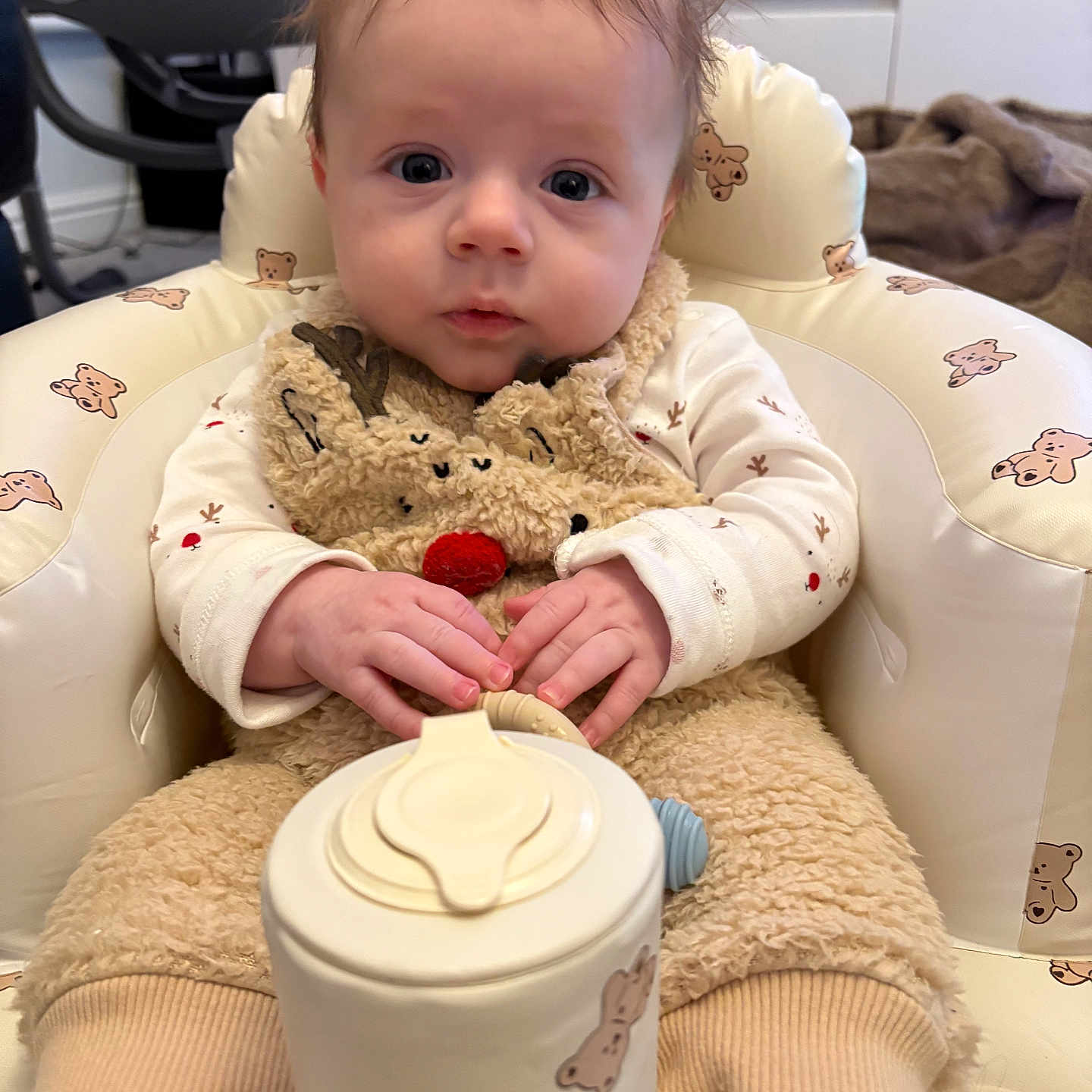 Leo is registered to the contest to win money with this photo: baby, beverage, bodypart, chair, coffee, coffeecup, couch, cutlery, eating, face, finger, food, furniture, hand, head, person, photography, portrait, sitting, spoon
