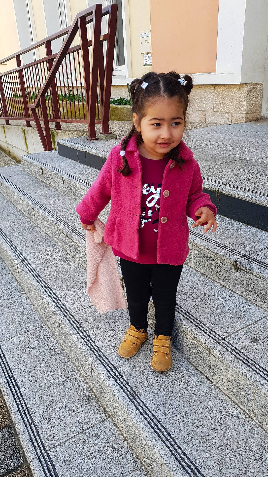 Soraya participe au concours pour gagner de l'argent avec cette photo : baby_toddler_clothing, city, denim, door, fun, hair, happy, joy, leisure, magenta, pattern, person, pink, recreation, sidewalk, sleeve, smile, street_fashion, temple, toddler