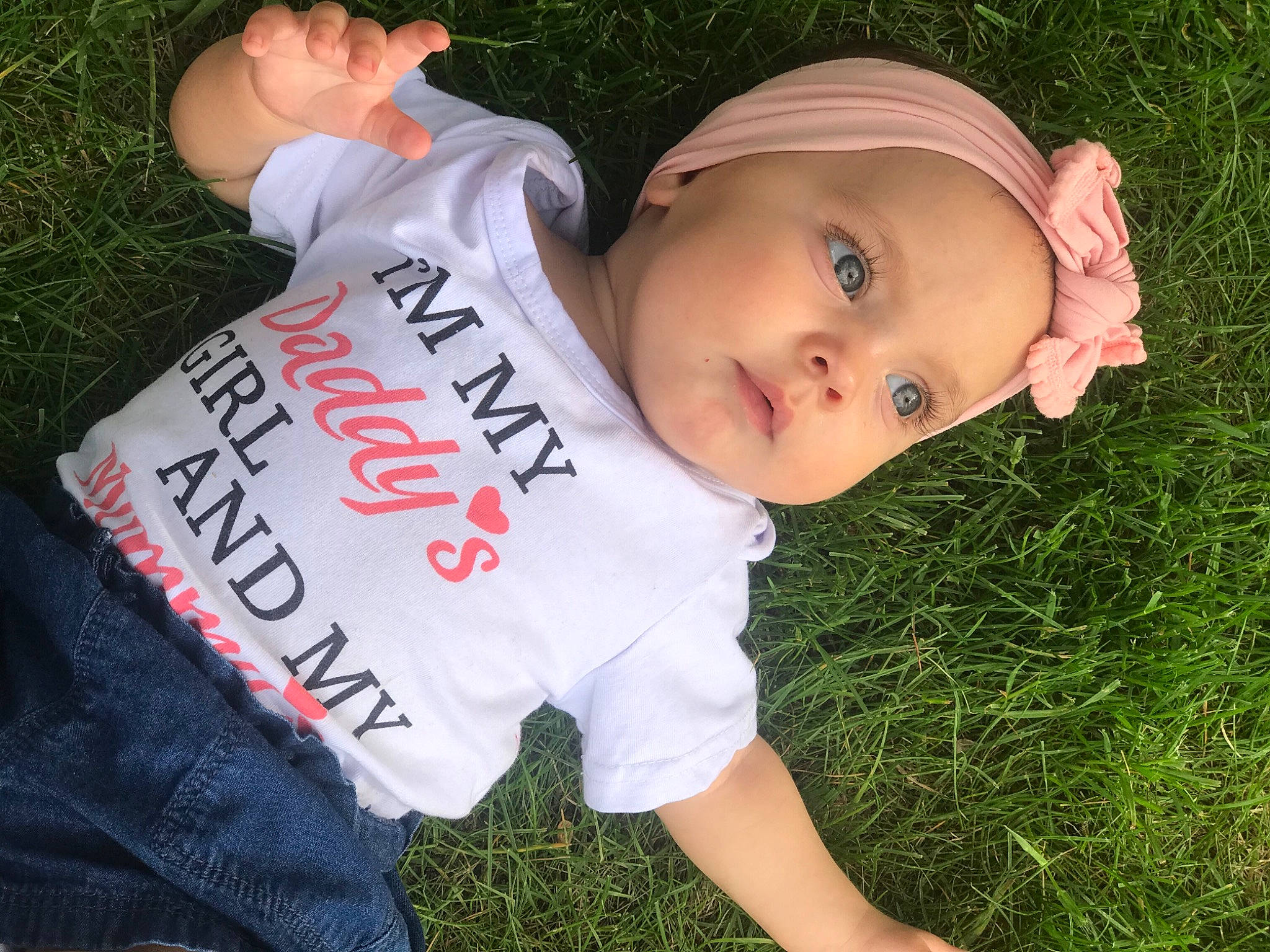 Kara joined the competition — help win amazing prizes! baby, baby_toddler_clothing, child, cool, finger, font, fun, grass, grass_family, hand, happy, hat, headwear, lawn, leisure, people_in_nature, person, plant, sitting, t_shirt