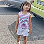 asphalt, bracelet, car, casual_clothing, child, cute, daylight, fashion, girl, happy, necklace, outdoor, parking_lot, portrait, sandals, shorts, smiling, standing, summer, tank_top