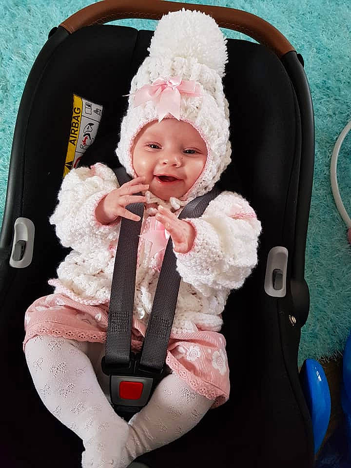 Maliah is registered to the contest to win money with this photo: baby, baby_carriage, baby_in_car_seat, baby_products, car_seat, child, fur, headgear, person, pink, product, toddler
