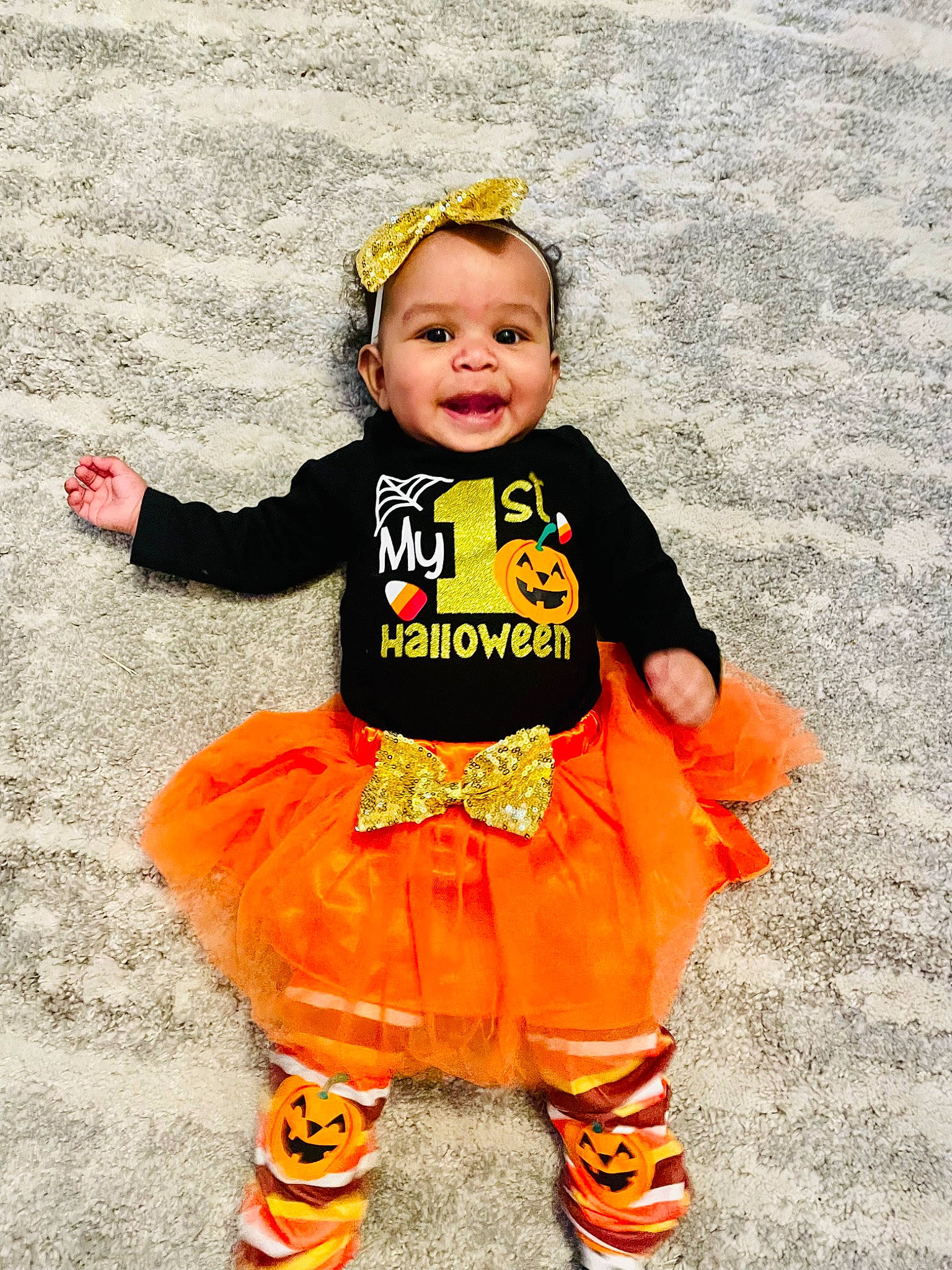 Emilia is registered to the contest to win money with this photo: baby, baby_toddler_clothing, child, costume, costume_hat, design, face, fun, happy, hat, head, orange, outerwear, pattern, person, sleeve, smile, standing, t_shirt, toddler