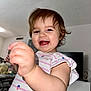 Allison joined the competition — help win amazing prizes! toddler, child, smiling, happy, indoor, person, face, hair, clothing, striped_shirt, living_room, furniture, television, toy, cute, skin, hand, portrait, expression, young