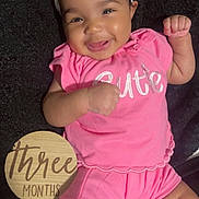 Novie joined the competition — help win amazing prizes! baby, infant, smile, pink_clothing, headband, bow, cute, happy, lying_down, milestone, wooden_plaque, three_months, fingers, cheeks, black_blanket, cute_expression, portrait, child, young_baby, celebration
