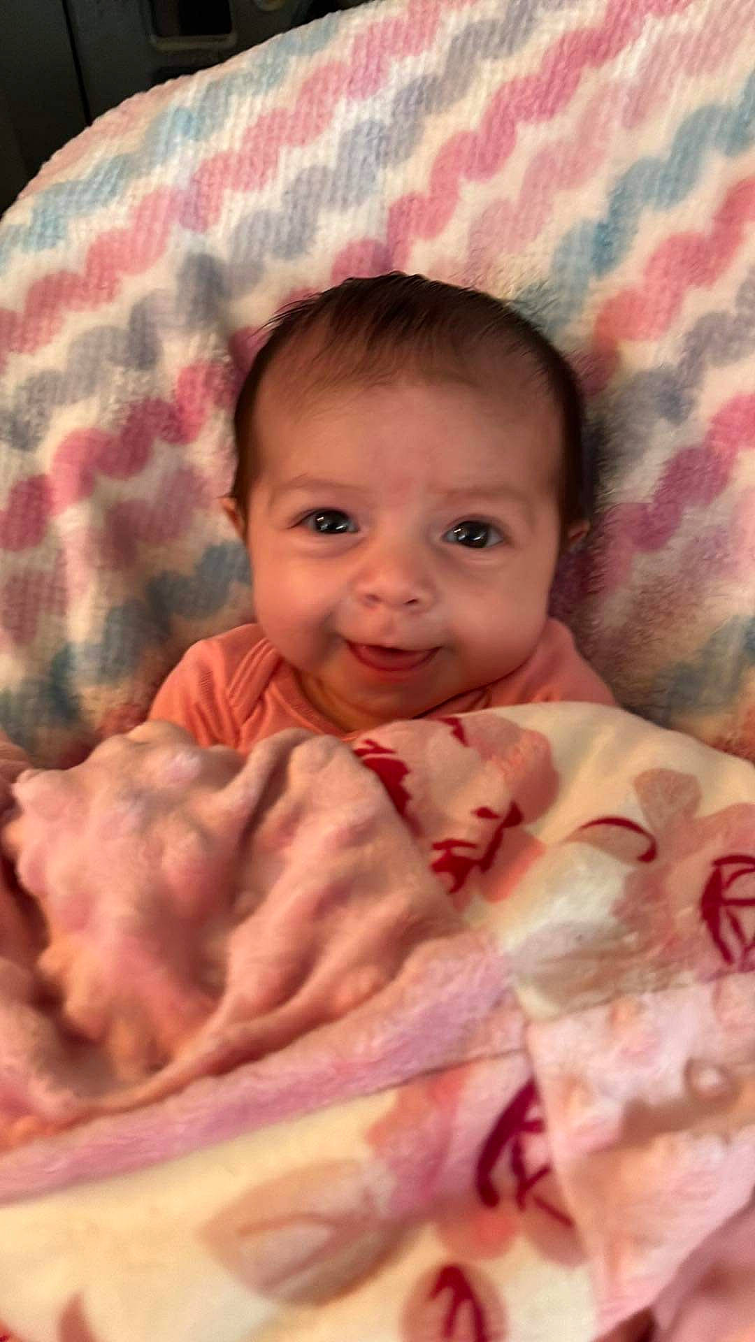 Kendall is registered to the contest to win money with this photo: baby, baby_toddler_clothing, cheek, child, chin, comfort, eyebrow, facial_expression, iris, joy, linens, lip, mammal, mouth, nose, person, pink, skin, sleeve, smile