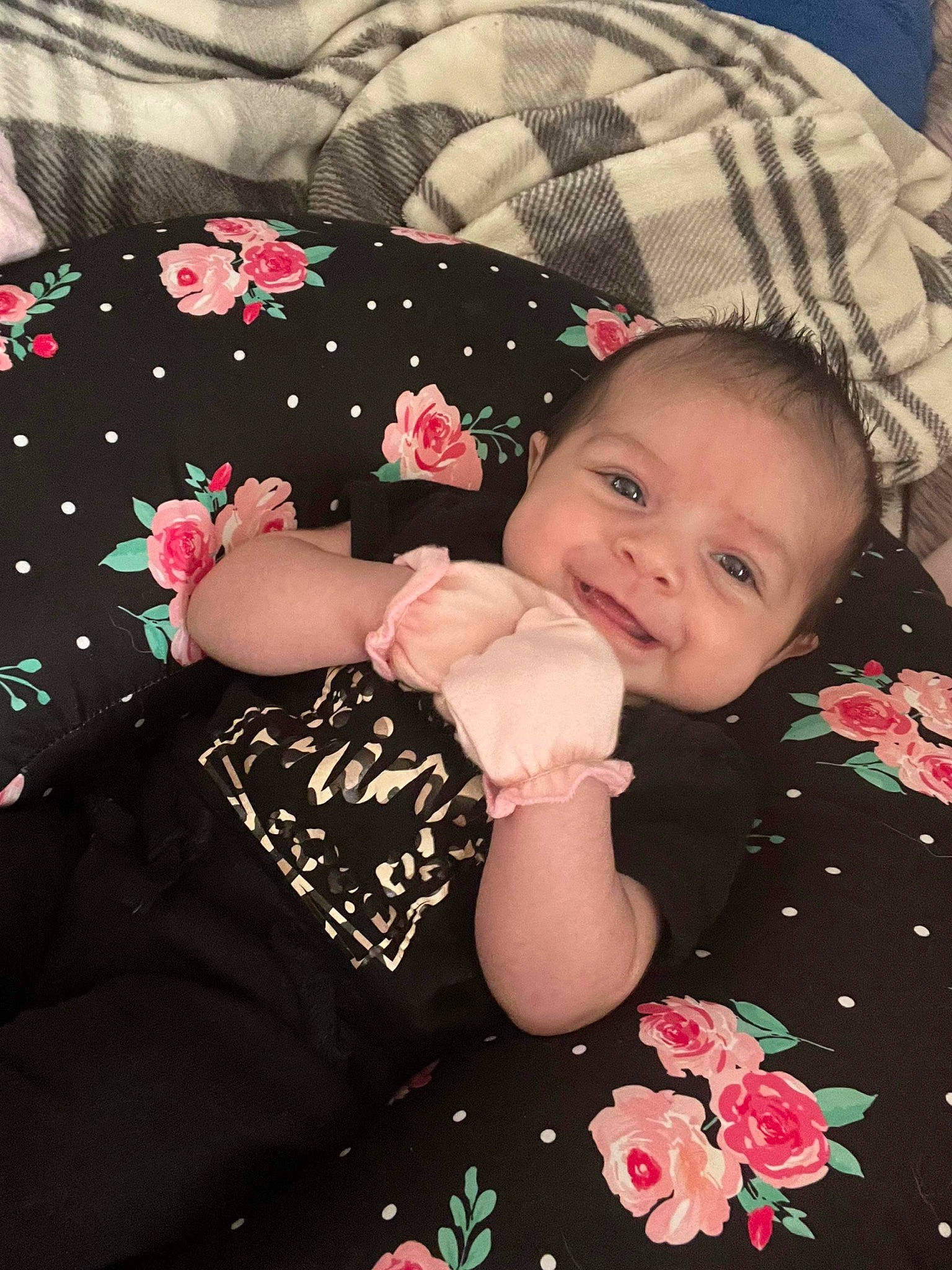 Kendall is registered to the contest to win money with this photo: baby, baby_toddler_clothing, cheek, child, comfort, face, finger, happy, head, joy, linens, lip, pattern, person, petal, pink, sitting, skin, sleeve, smile