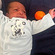 Kelysha a rejoint le concours — aidez-le/la à gagner de superbes lots ! arm, baby, blanket, child, clothing, cozy, cute, expression, face, fruit, indoors, infant, lying_down, newborn, orange, panda, portrait, resting, soft, wearing