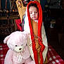 Kailecelove joined the competition — help win amazing prizes! baby, cradleboard, plush_toy, teddy_bear, red_checkered_blanket, wooden_furniture, indoor, child, face, expression, cozy, traditional, home_decor, person, soft_toy, sitting, wrapped, room, child_baby, portrait