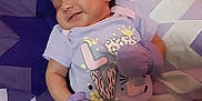 Kailecelove is registered to the contest to win money with this photo: baby, infant, sleeping, smile, mittens, purple, shirt, pattern, quilt, geometric_pattern, bed, child, cute, happy, relaxing, portrait, small_person, soft_lighting, indoor, resting