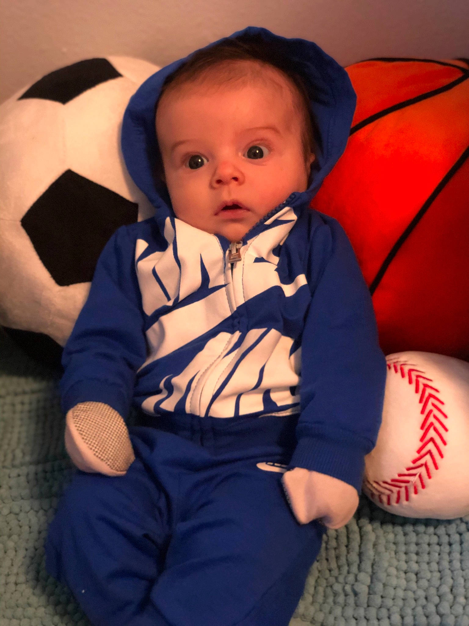 Jamison is registered to the contest to win money with this photo: arm, baby, baby_toddler_clothing, cheek, comfort, electric_blue, eye, finger, flash_photography, head, iris, mouth, neck, orange, person, skin, sleeve, sports_equipment, standing, thigh