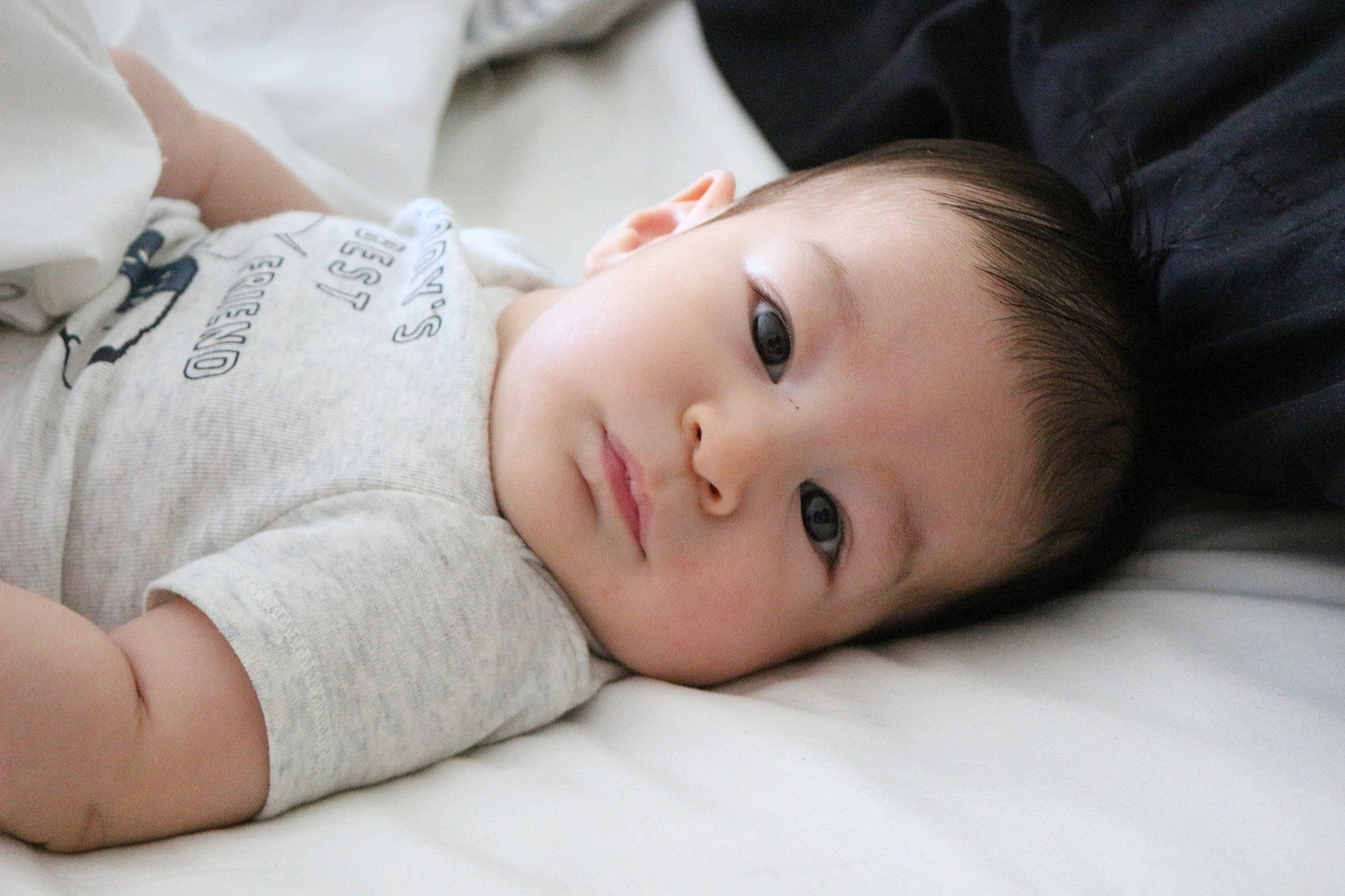 Emerson is registered to the contest to win money with this photo: baby, baby_toddler_clothing, cheek, child, comfort, eyelash, flash_photography, grass, human_body, lip, neck, no_expression, nose, pattern, person, portrait_photography, sitting, skin, sleeve, toddler