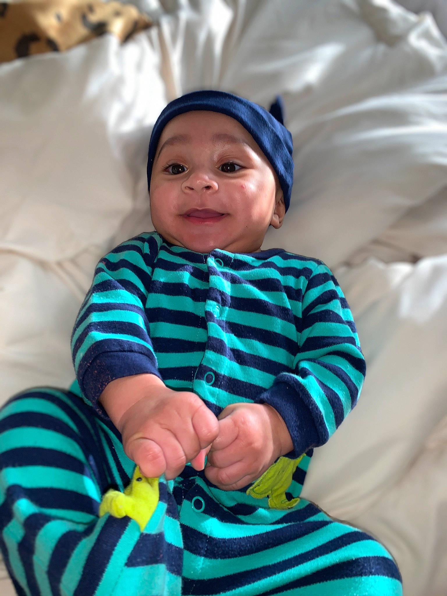 Dave is registered to the contest to win money with this photo: baby, baby_toddler_clothing, child, comfort, electric_blue, fun, happy, hat, headwear, human, linens, pattern, person, play, purple, sitting, skin, sleeve, smile, t_shirt
