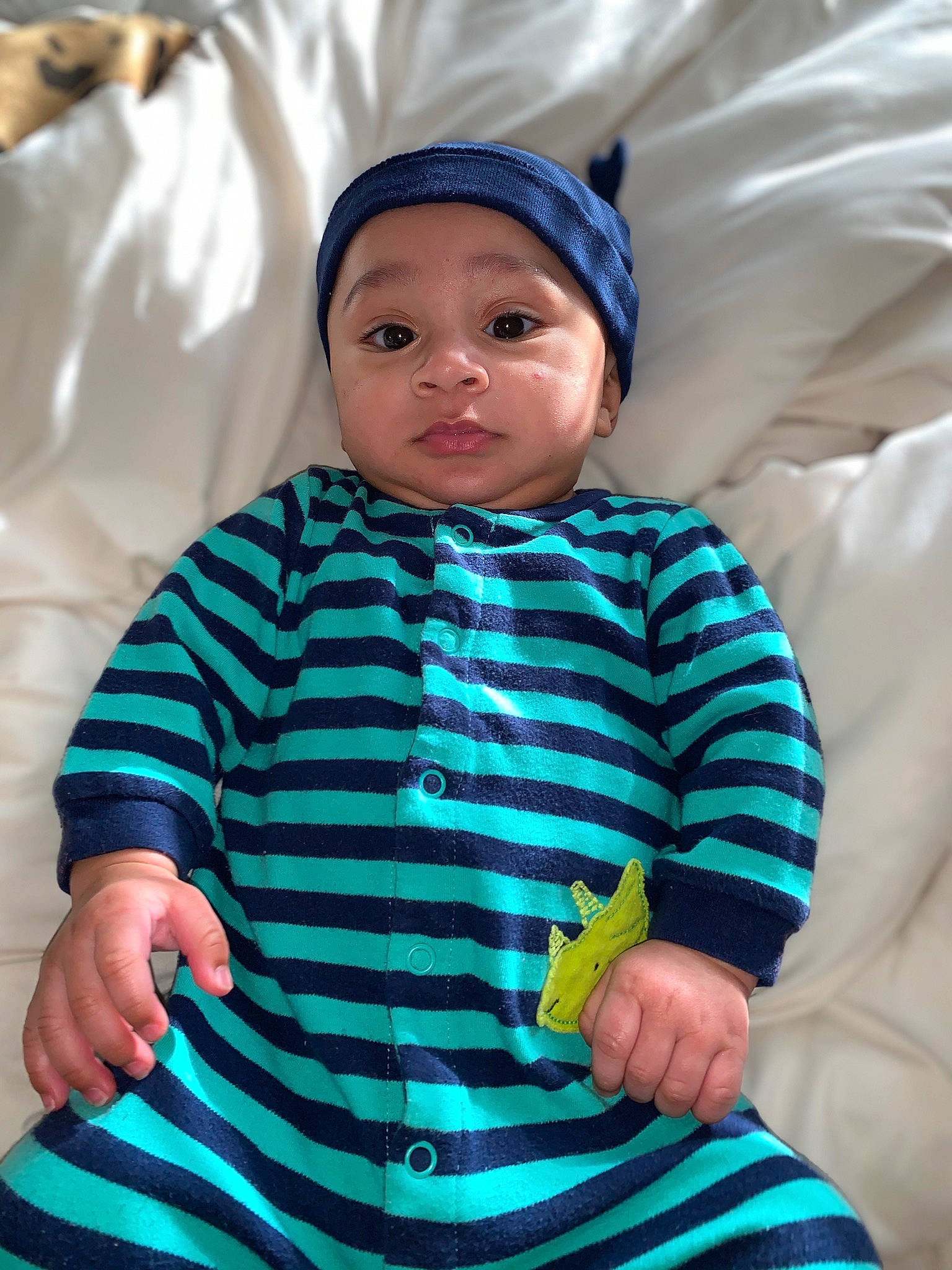 Dave is registered to the contest to win money with this photo: baby, baby_products, baby_toddler_clothing, cap, cheek, child, comfort, electric_blue, eye, face, happy, hat, headwear, hood, hoodie, linens, person, sitting, sleeve, smile