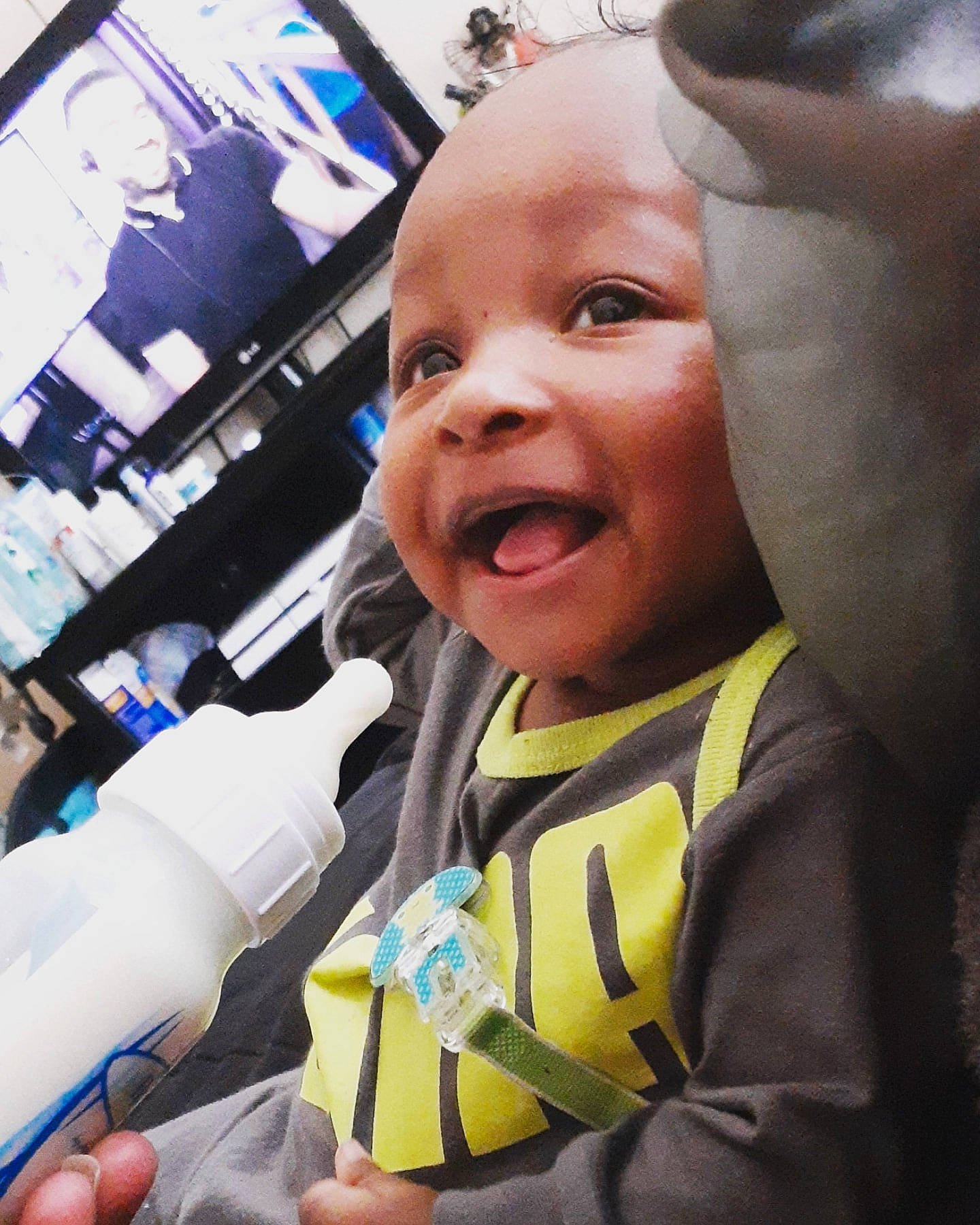 Dakari joined the competition — help win amazing prizes! baby, baby_laughing, bottle, drinkware, finger, gesture, glove, happy, machine, person, personal_protective_equipment, plastic_bottle, safety_glove, selfie, service, skin, smile, thumb, toddler, tooth