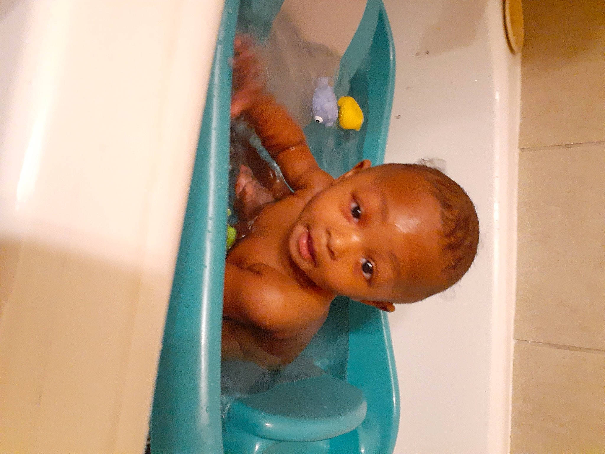 Dakari is registered to the contest to win money with this photo: abdomen, baby, baby_products, baby_toys, barechested, bathing, chest, child, fun, happy, leisure, person, plastic, play, room, thumb, toddler, toy