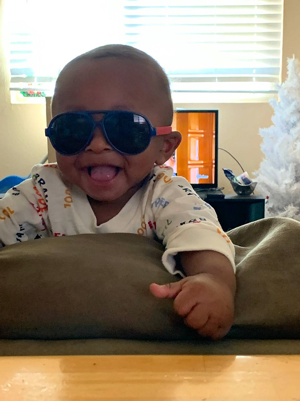 Dakari joined the competition — help win amazing prizes! chin, comfort, elbow, eyewear, flooring, fun, goggles, hairstyle, hardwood, human_leg, knee, person, personal_protective_equipment, sleeve, sunglasses, t_shirt, toddler, vision_care, window, window_blind