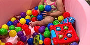 Natalieah is registered to the contest to win money with this photo: toddler, child, ball_pit, colorful_balls, pink, toy, indoor, smiling, happy, playtime, floor, plastic_balls, candid, baby, fun, sitting, cute, joy, person, play