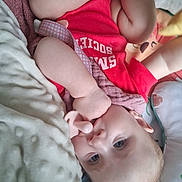 Olivia A joined the competition — help win amazing prizes! baby, infant, pacifier, red_shirt, blanket, pillow, soft_texture, lying_down, face, blue_eyes, skin, hand, arm, cute, indoors, child, clothing, comfort, resting, portrait