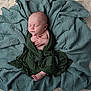 Oliver is registered to the contest to win money with this photo: newborn, baby, sleeping, wrapped, blanket, green_cloth, soft_texture, peaceful, infant, portrait, cozy, hands, feet, head, skin, cushion, resting, indoors, closeup, cute