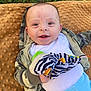 baby, child, smiling, plush_toy, blanket, outdoor, grass, hoodie, camouflage, blue_pants, happy, infant, face, person, cute, toy, lying_down, young_child, nature, playful