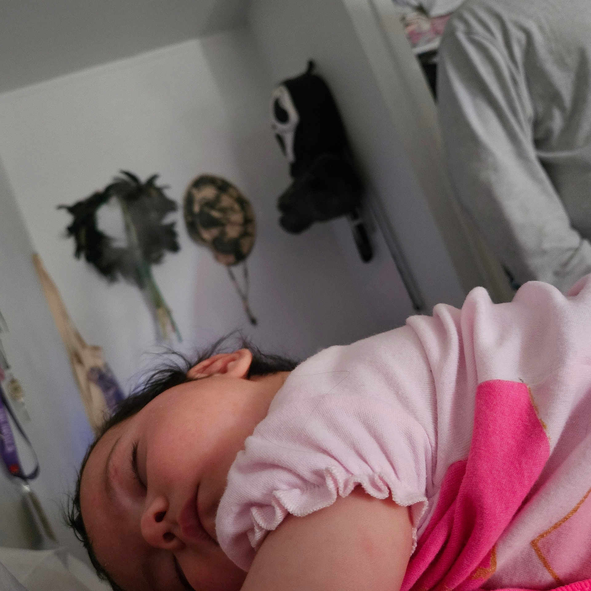 Selina is registered to the contest to win money with this photo: baby, sleeping, pink_clothing, closeup, indoor, wall, decoration, mask, dried_plants, peaceful, child, portrait, person, soft_light, relaxation, head, hair, face, cozy, room