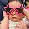 baby, child, closeup, clothing, cute, expression, face, fashion, fingers, hand, holding, indoor, infant, people, person, pink, portrait, skin, star_shaped, sunglasses