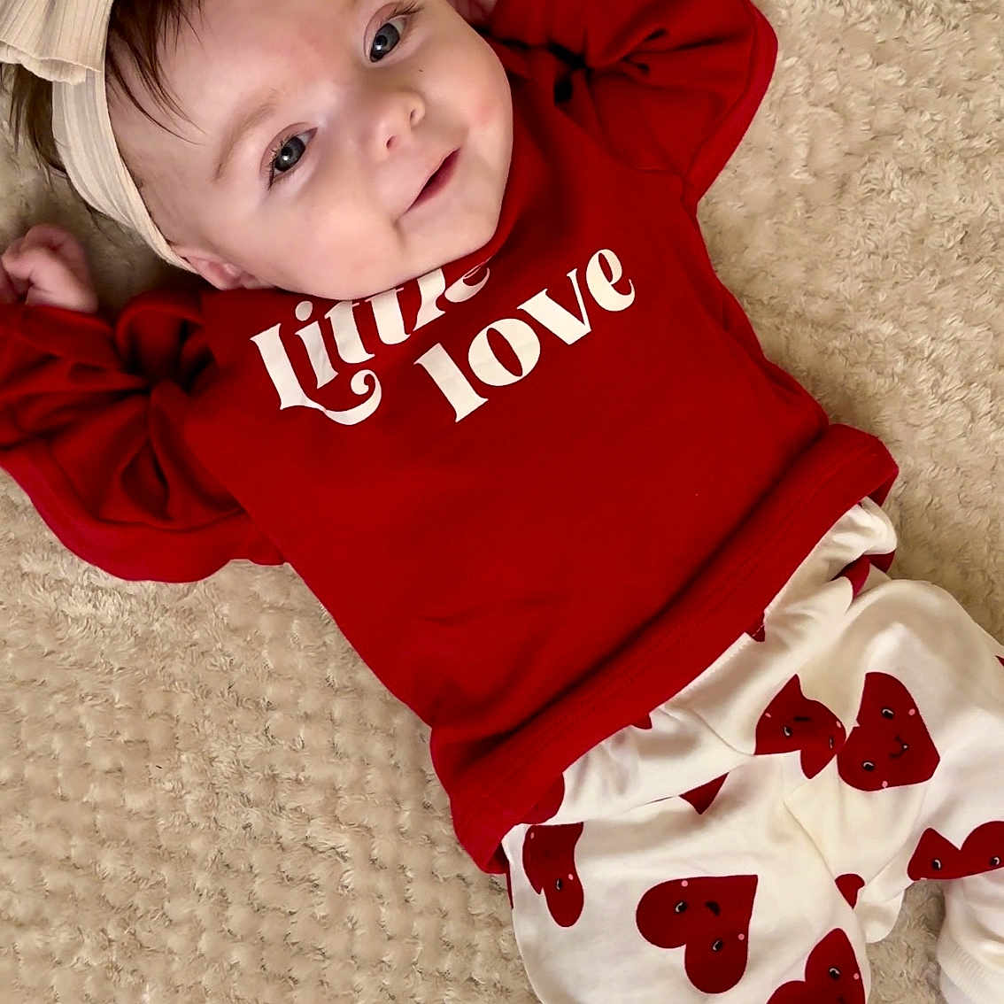 Athena is registered to the contest to win money with this photo: applique, baby, bed, bedroom, blanket, bodypart, bonnet, cap, clothing, costume, couch, cushion, face, finger, furniture, glove, hand, happy, hat, head