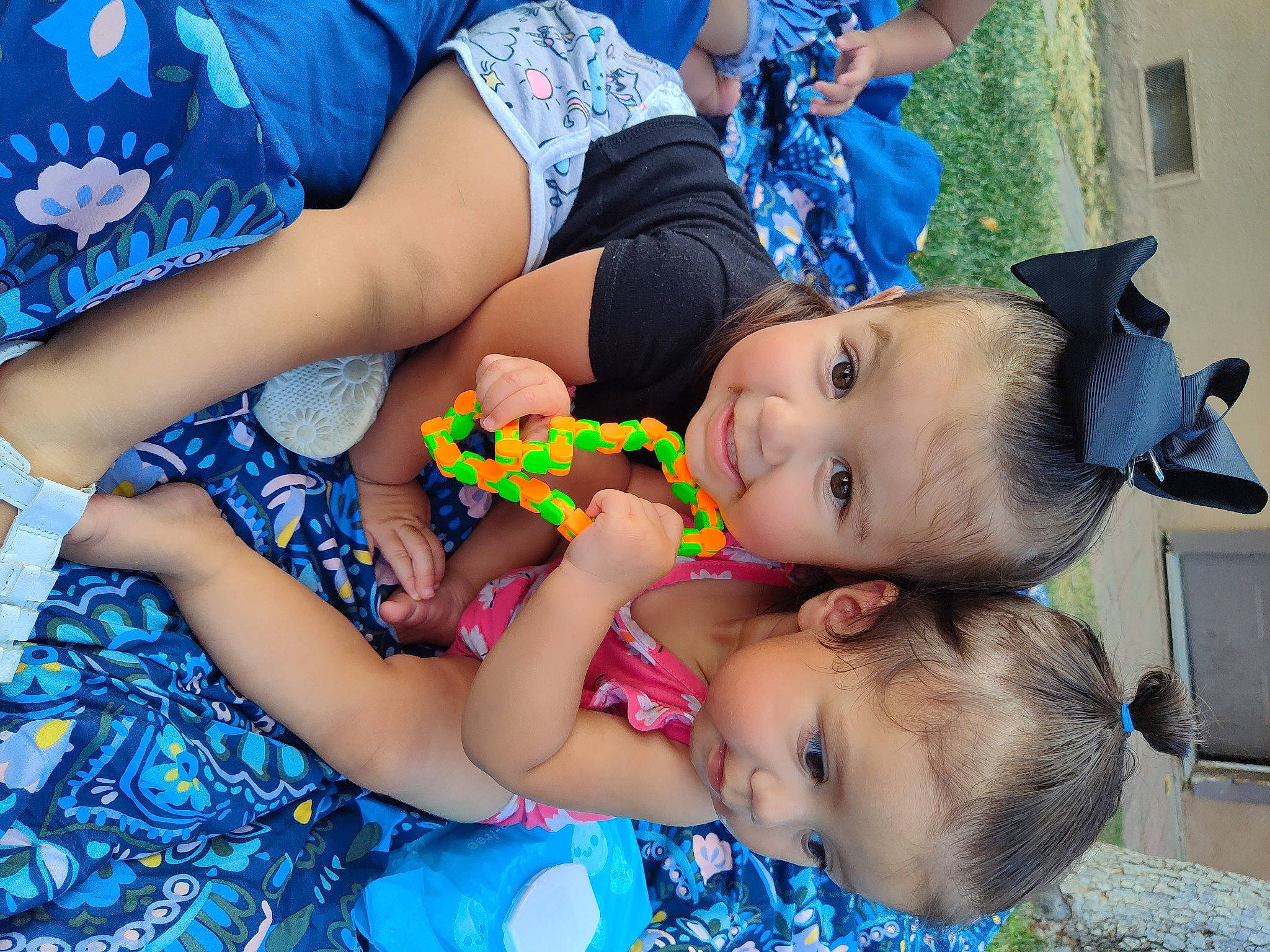 Addilyn is registered to the contest to win money with this photo: baby, blue, child, electric_blue, event, fun, grass, green, happy, human_leg, leisure, mouth, nail, people, person, red, skin, thigh, toddler, toy