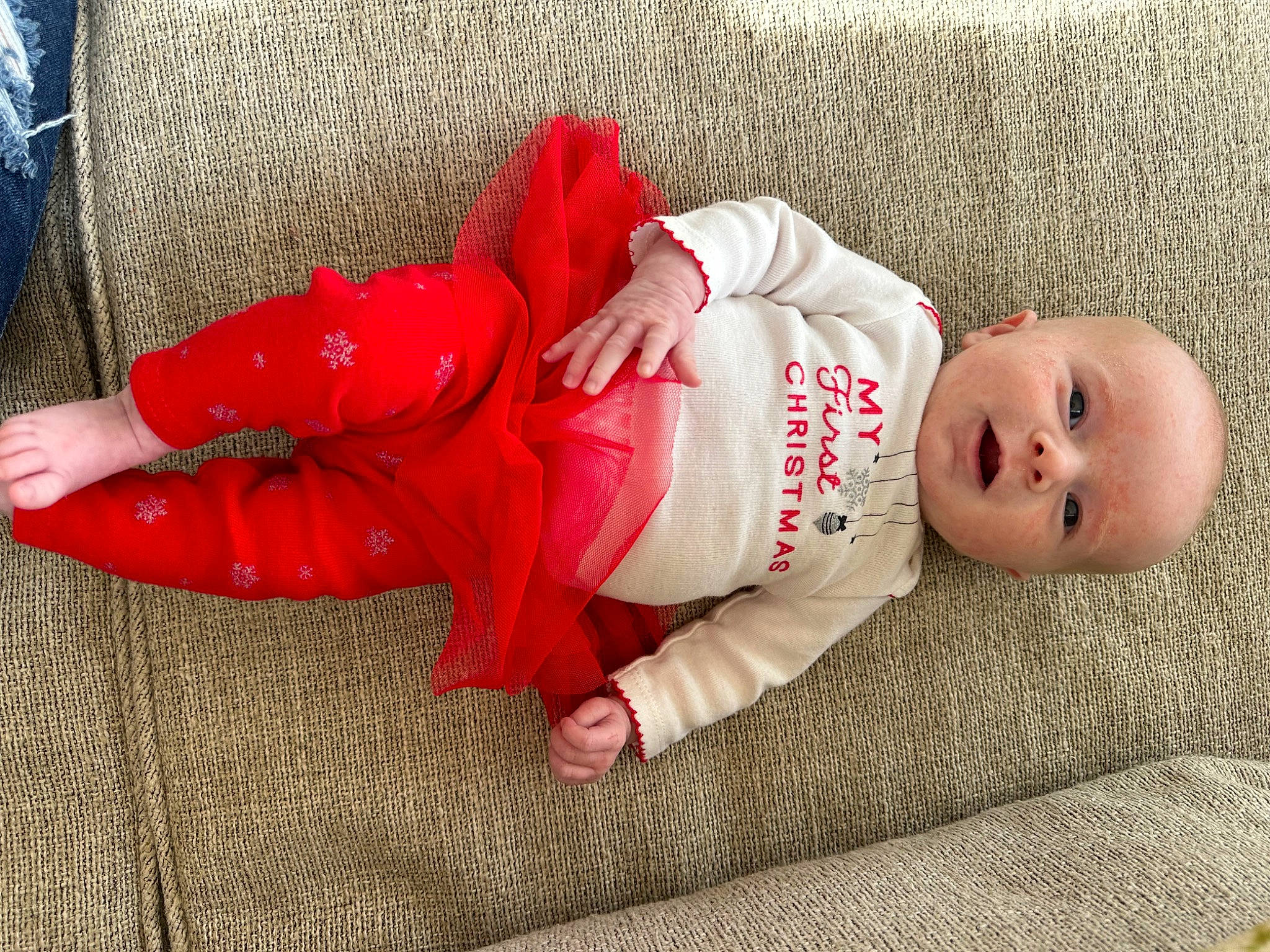 Brynlee is registered to the contest to win money with this photo: baby, baby_sleeping, baby_toddler_clothing, carmine, child, comfort, eye, flooring, foot, hand, head, headgear, human_body, human_leg, linens, person, sitting, skin, sleeve, toddler