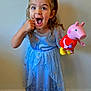 Ellie is registered to the contest to win money with this photo: child, girl, princess_dress, blue_dress, pigtails, barefoot, toy, peppa_pig, funny_face, expression, indoor, floor, wall, standing, curly_hair, happy, playing, cute, smiling, person