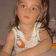 Logan Fournier a rejoint le concours — aidez-le/la à gagner de superbes lots ! toddler, child, toy, indoor, person, sleeveless_top, cartoon_print, face, hands, brown_hair, young_child, expression, playtime, cute, looking_away, closeup, skin, eyes, background, holding