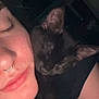 person, cat, black_cat, sleeping, close_up, face, nose_ring, skin, ear, animal, pet, snuggling, cozy, rest, dark_background, eyelashes, human, indoor, affection, quiet