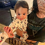 Braxton Jaxx is registered to the contest to win money with this photo: adult, child, clothing, curious, cute, family, hand, home, indoor, living_room, mickey_mouse, mirror, pajamas, person, phone, reflection, selfie, sofa, table, toddler