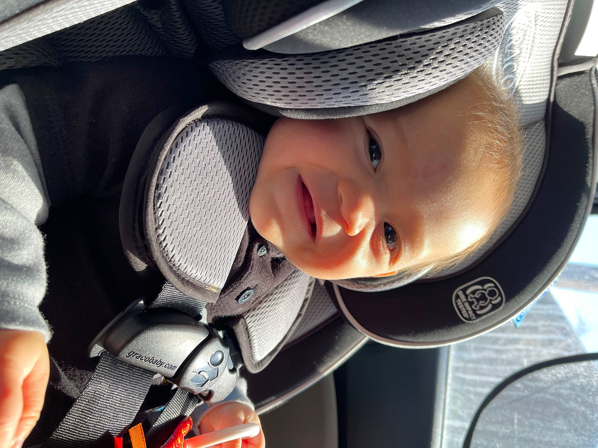 Ronin is registered to the contest to win money with this photo: auto_part, automotive_design, automotive_exterior, automotive_lighting, baby, baby_carriage, car_seat, child, comfort, cool, face, hat, head, headgear, mouth, person, smile, sun_hat, toddler, vehicle_door