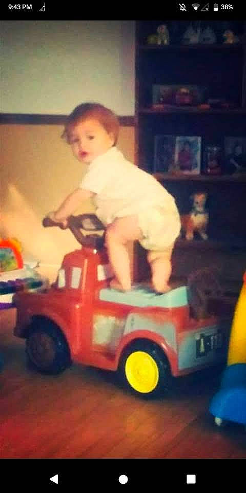 Clayton is registered to the contest to win money with this photo: automotive_design, automotive_exterior, automotive_tire, automotive_wheel_system, bookcase, child, fender, fun, happy, mode_of_transport, model_car, motor_vehicle, person, riding_toy, shelf, tire, toddler, toy, toy_vehicle, vehicle