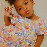 Cemaryah is registered to the contest to win money with this photo: child, girl, portrait, smiling, posing, floral_dress, colorful, cute, peace_sign, puffed_hair, ponytail, indoor, playful, expression, fashion, young_child, skin, hand, face, person