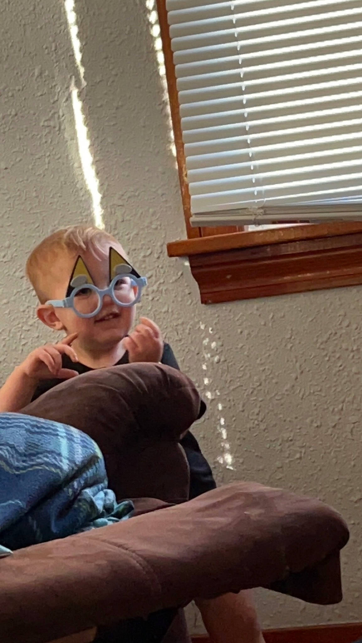 Parker is registered to the contest to win money with this photo: comfort, denim, elbow, eyewear, facial_hair, flooring, fun, human_leg, knee, leg, person, personal_protective_equipment, room, sitting, thigh, vision_care, window, window_blind, window_covering, window_treatment