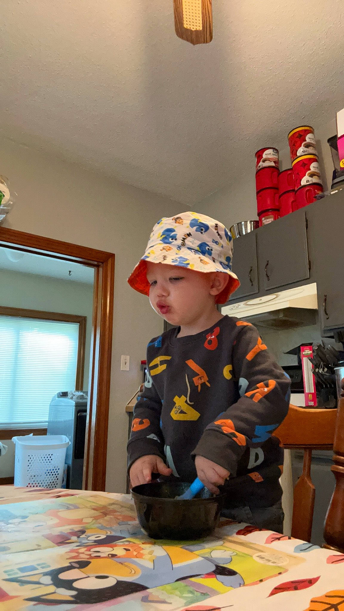 Parker joined the competition — help win amazing prizes! baby, baseball_cap, cabinetry, cap, chair, child, desk, door, flooring, fun, hat, headwear, person, personal_protective_equipment, play, room, sitting, soldier, table, toddler