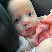 Elisa participe au concours pour gagner de l'argent avec cette photo : baby, infant, face, eyes, blanket, clothing, pink, cushion, car_seat, portrait, closeup, young_child, cute, soft_light, skin, expression, comfort, resting, small_hand, newborn