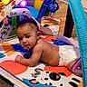 Kolsen is registered to the contest to win money with this photo: animal_cartoon, baby, baby_gym, blue, child, colorful, cute, diaper, floor, indoor, infant, light, mirror, orange, play, playmat, purple, reflection, toy, wooden_floor